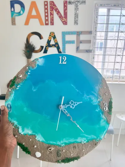 A vibrant, tropical-themed resin clock with bright turquoise water and a sandy shore, perfect for adding a pop of color to any room.
