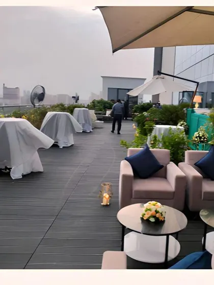 Another perspective of the rooftop venue, showing the mix of lounge seating and standing tables. This flexibility allows guests to mingle comfortably while enjoying our food and drinks.