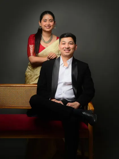 A stylish and formal seated portrait of the couple. This composition is balanced and elegant, perfect for a pre-wedding album.