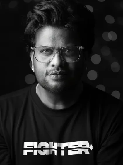 A strong, black and white portrait for a male model. The 'Fighter' t-shirt and direct gaze create a powerful and confident look.