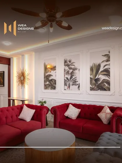 A close-up of the vibrant red Chesterfield sofa, set against a backdrop of botanical art within classic wall panels. This shows our ability to integrate bold colors into a sophisticated design.