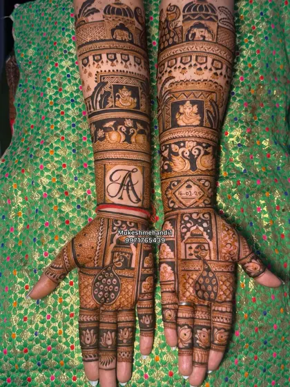 A classic Rajasthani bridal design with bands of different traditional patterns, including elephants, peacocks, and the couple's initial 'A'.