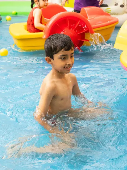 This young guest is enjoying our paddle boat, a unique and fun activity available in our splash zone.