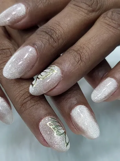 A delicate and ethereal design. This look features a shimmery white glitter base with a simple, elegant butterfly outline hand-painted in gold.