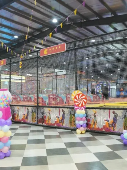 A wide view of the Candyland party setup, showing how the decorations integrate with our play area for a seamless party experience.