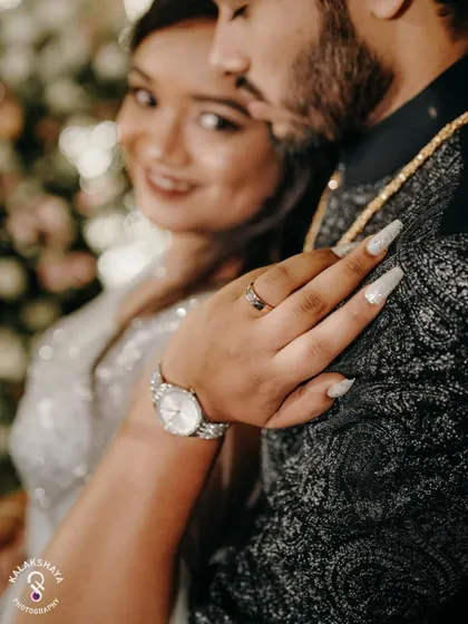 A close-up shot focusing on the bride's hand, showing off her ring and nails.