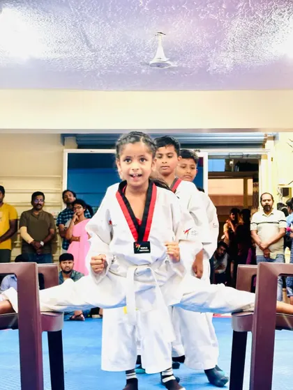 A young girl shows her amazing flexibility with a chair split.