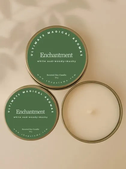 The 'Enchantment' mini candle, featuring notes of white oud, woody, and musk. It's a sophisticated scent in a convenient small package.