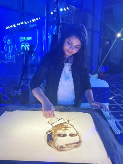 Another angle from a recent live show, focused on creating a detailed sand portrait. I am always grateful for the opportunity to share my art.