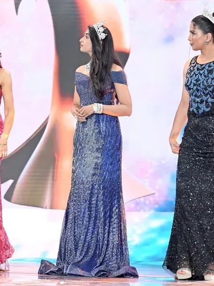 Contestants on stage during the pageant. This shot captures the anticipation and poise of the models during the competition.