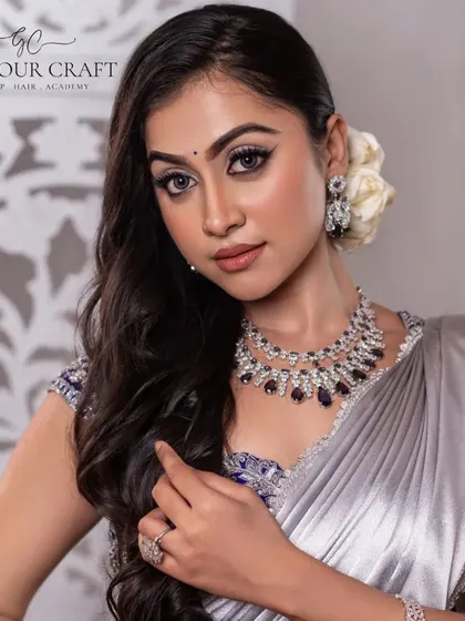 A model looking glamorous in a silver-toned saree, paired with our modern diamond-look necklace with deep blue stones. This is a perfect cocktail or reception look.