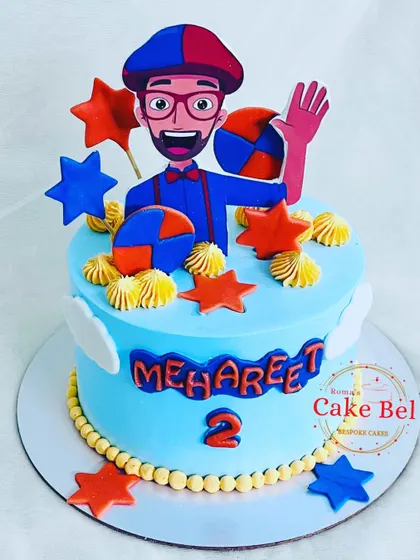 A fun Blippi-themed cake for a curious two-year-old. The bright orange and blue colors, stars, and cheerful Blippi topper make this a playful centerpiece for any toddler's party.