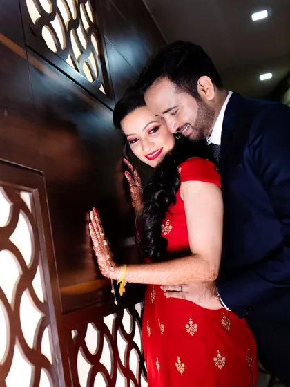 An intimate and romantic pose against a textured wall, perfect for a reception album.