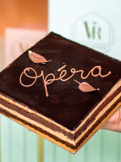 Our take on the French Opera cake. It has layers of almond sponge, coffee buttercream, and chocolate ganache. Every bite is a perfect foodgasm.