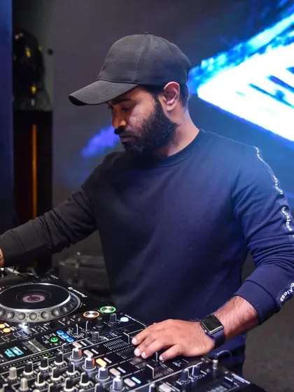 In the zone, focused on the mix. A huge part of my job is reading the crowd and selecting the perfect track to play next, keeping the energy flowing all night long.