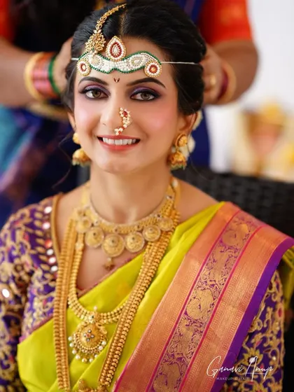 This bride looks radiant in her lime green and purple Kanjeevaram. I used a subtle purple eyeshadow to complement her saree and kept the rest of the makeup dewy and fresh.