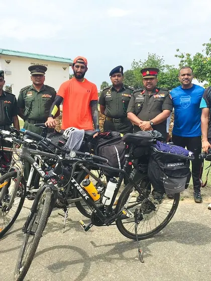 Posing with the Sri Lankan army during our cycling adventure. We met so many amazing people along the way.