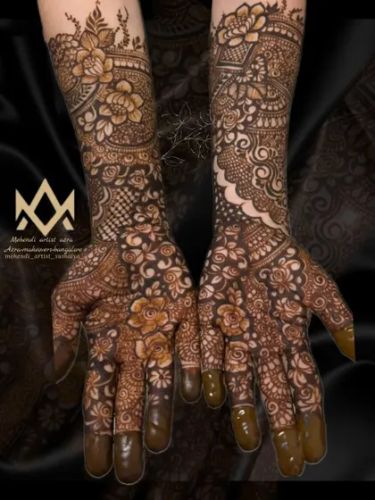 A heavy non-bridal mehendi design that covers the full arms, perfect for an engagement or a close family member of the bride.