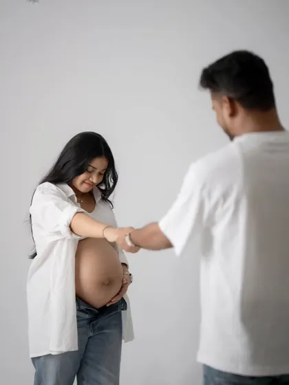 A playful and sweet fist bump with the baby bump. This shot captures the fun and excitement of waiting to meet their new family member.
