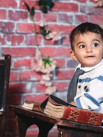 A gallery of our popular school and library theme. These images show the versatility of the brick wall backdrop, mini school desk, globe, and book props for creating a variety of scholarly and classic portraits.