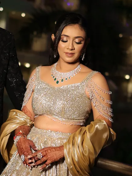 A portrait of the bride showing the intricate beading on her gown and her perfectly coordinated makeup.