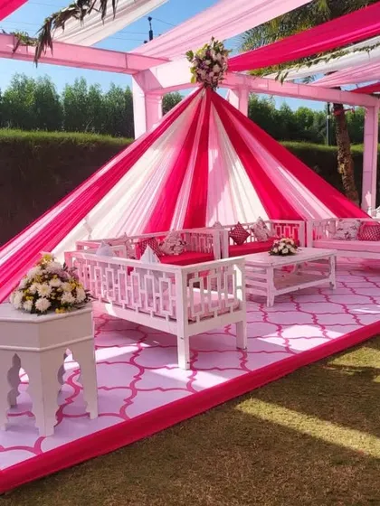 A beautiful outdoor Mehndi seating arrangement. I used a pink and white draped cabana with elegant white furniture to create a comfortable and stylish lounge area for guests.