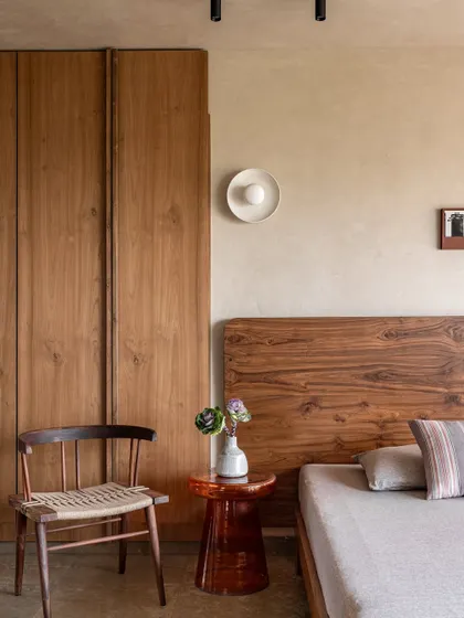 A closer look at the master bedroom's warm and simple aesthetic. The custom-designed furniture and natural wood tones create a serene atmosphere, harmonizing with the home's overall wabi-sabi feel.