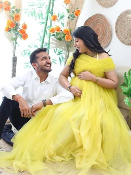 A happy, light-filled moment in my bohemian-themed studio corner. The bright yellow gown adds a touch of sunshine to this cheerful and candid maternity photo.