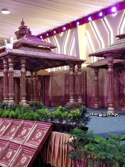An expansive, multi-tiered stage setup designed to resemble a traditional temple complex. This vintage style decor creates a timeless and immersive experience for the wedding celebration.
