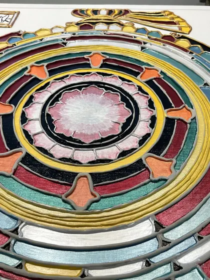 A detailed view of the painted "Siddha Chakra," showing the vibrant colors and the central lotus, which symbolizes purity and enlightenment.