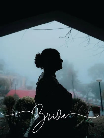 A silhouette of the bride against a misty, foggy window. This is a creative and moody shot that tells a story about the mountain weather on her wedding day.