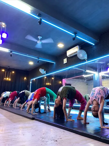 Our students work together on their backbends. Practicing in a group helps with motivation and allows our instructors to provide form corrections to the entire class.