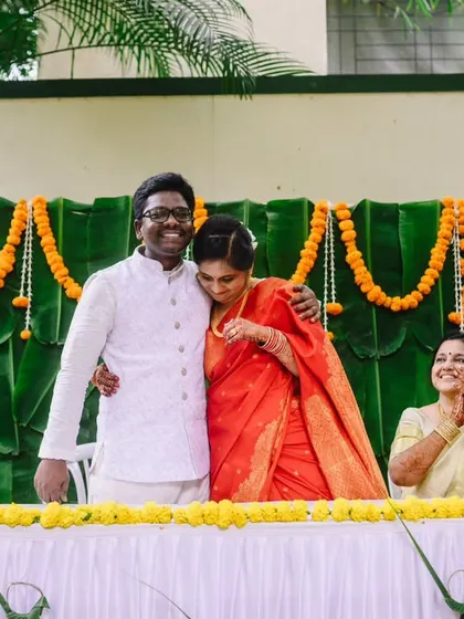 A heartfelt hug after the ceremony. The emotions are running high, and the support from family, seen clapping in the background, makes the moment even more special.