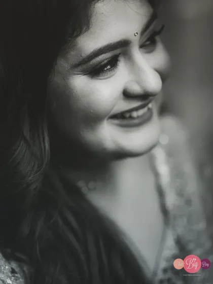 A soft and gentle black and white portrait of the bride, Saloni, her happy expression the main focus.