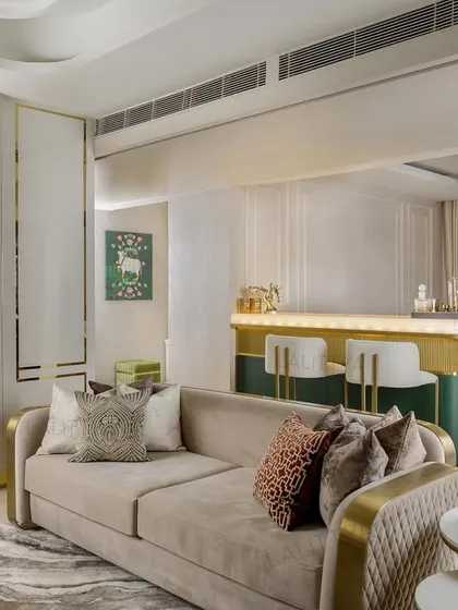 A seamless transition from the living area to the bar. The design uses architectural elements like a floating mirror and consistent color palettes to ensure different functional zones feel part of a cohesive whole.
