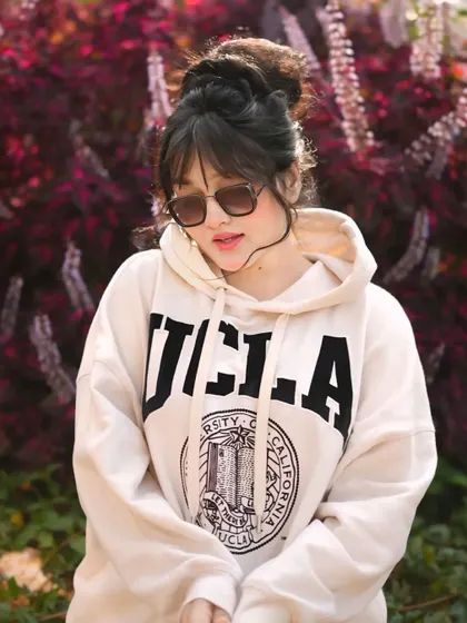 A casual, cool look for an influencer, shot outdoors with natural greenery. This style is perfect for everyday fashion content.