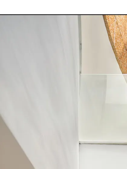 An abstract detail of the architecture, focusing on the clean lines, curves, and textures that define the space.