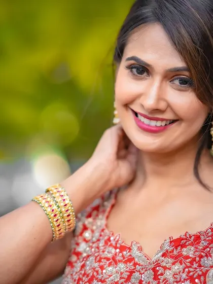 A happy, confident smile is the best accessory. The makeup here is designed to enhance that, with a focus on radiant skin and a bright lip.