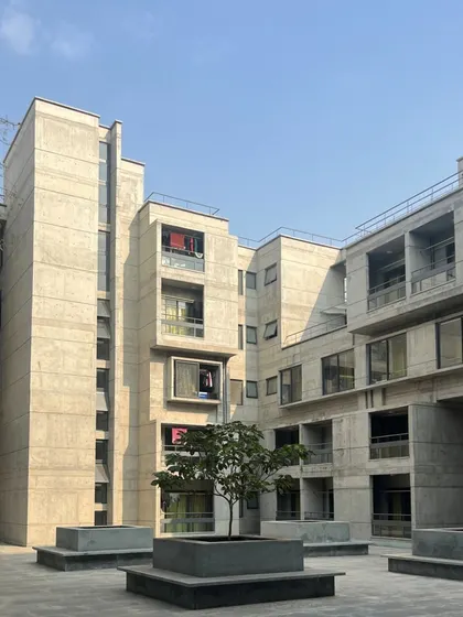 The central courtyard of the new hostel, surrounded by the G+4 structure. This classic design model proves successful in creating a hub of activity and visual connection across all levels.