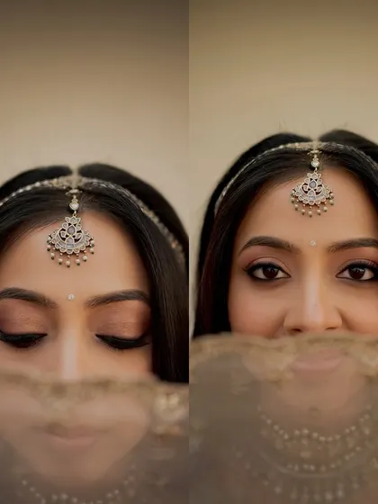 A playful peek-a-boo through the veil. This close-up shows the soft winged liner and shimmery eyeshadow that define her eyes.