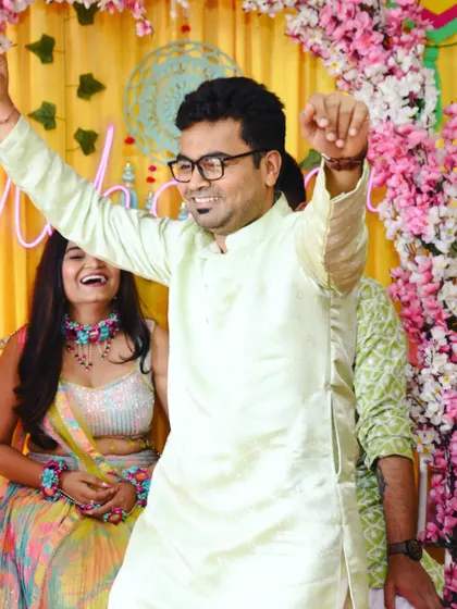 A candid shot of a guest dancing with joy at the Mehendi.