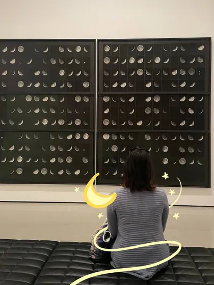 Admiring the phases of the moon at an art gallery, with some moon and star doodles to match.