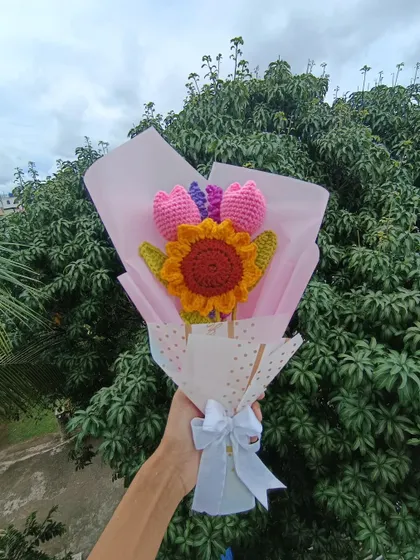 A custom bouquet featuring a sunflower and tulips, wrapped and ready.