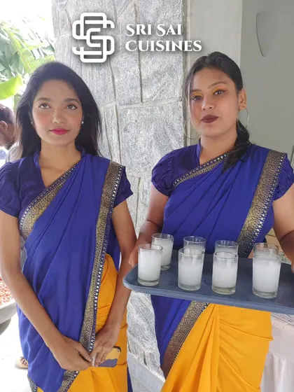 We seamlessly blend tradition with professional service. Here, two of our hostesses in beautiful yellow and blue sarees are serving welcome drinks, a perfect choice for traditional ceremonies, engagements, and weddings where cultural attire is preferred.