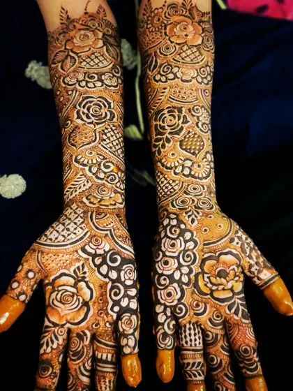 The stain on this bridal design is developing beautifully, showing the intricate details of the floral and paisley patterns.