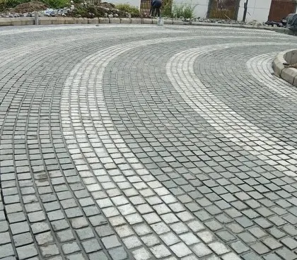 The finished curved cobblestone driveway, showing how the pattern follows the flow of the road.
