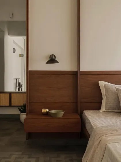 A view from the bed in a room at Apartment 1005, looking towards the wood-paneled wall and dressing area.