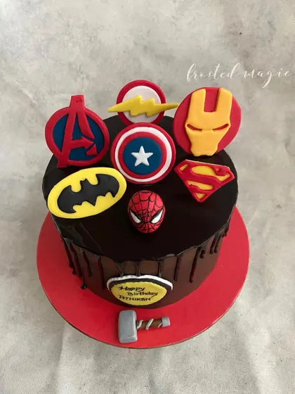 When you can't choose just one superhero, why not have them all? This chocolate drip cake is decorated with the logos of famous heroes like Batman, Superman, and the Avengers, perfect for a superhero mega-fan.