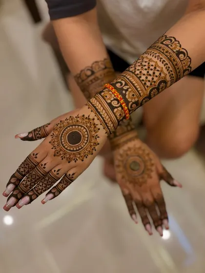 A Diwali mehendi design for Jasleen, with a central mandala on the palm and dense, traditional patterns on the arm.