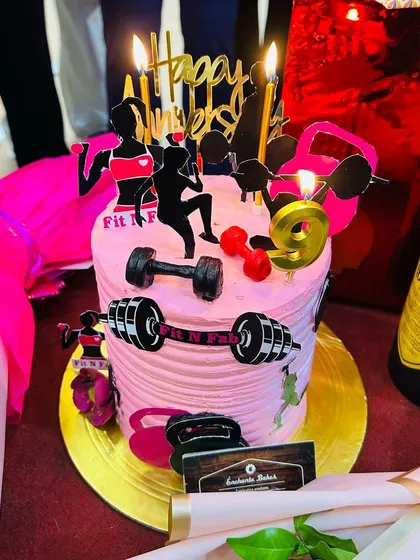 A close-up of our fantastic 9th-anniversary cake for the Paschim Vihar branch, complete with fitness-themed decorations.